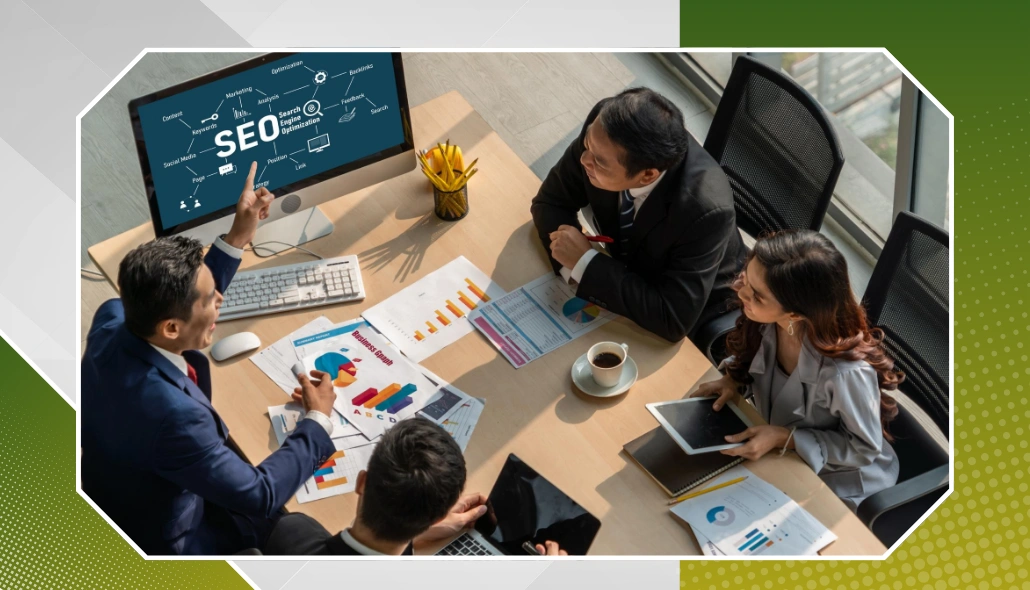 Team in a meeting analyzing SEO performance charts on a computer screen